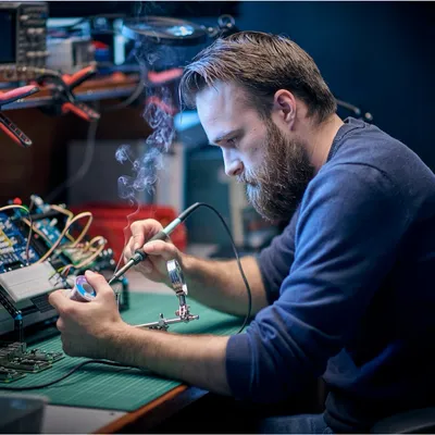 An engineer soldering a prototype board at the Lab271 workbench